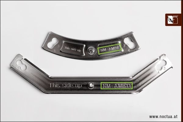 Two AMD mounting bars, one with the engraving "This side up" and "NM-AMB8", one with "This side up" and "NM-AMB11"