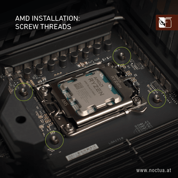 Close-up of an AMD AM5 CPU socket, four screw threads surrounding the socket are highlighted for cooler mounting.