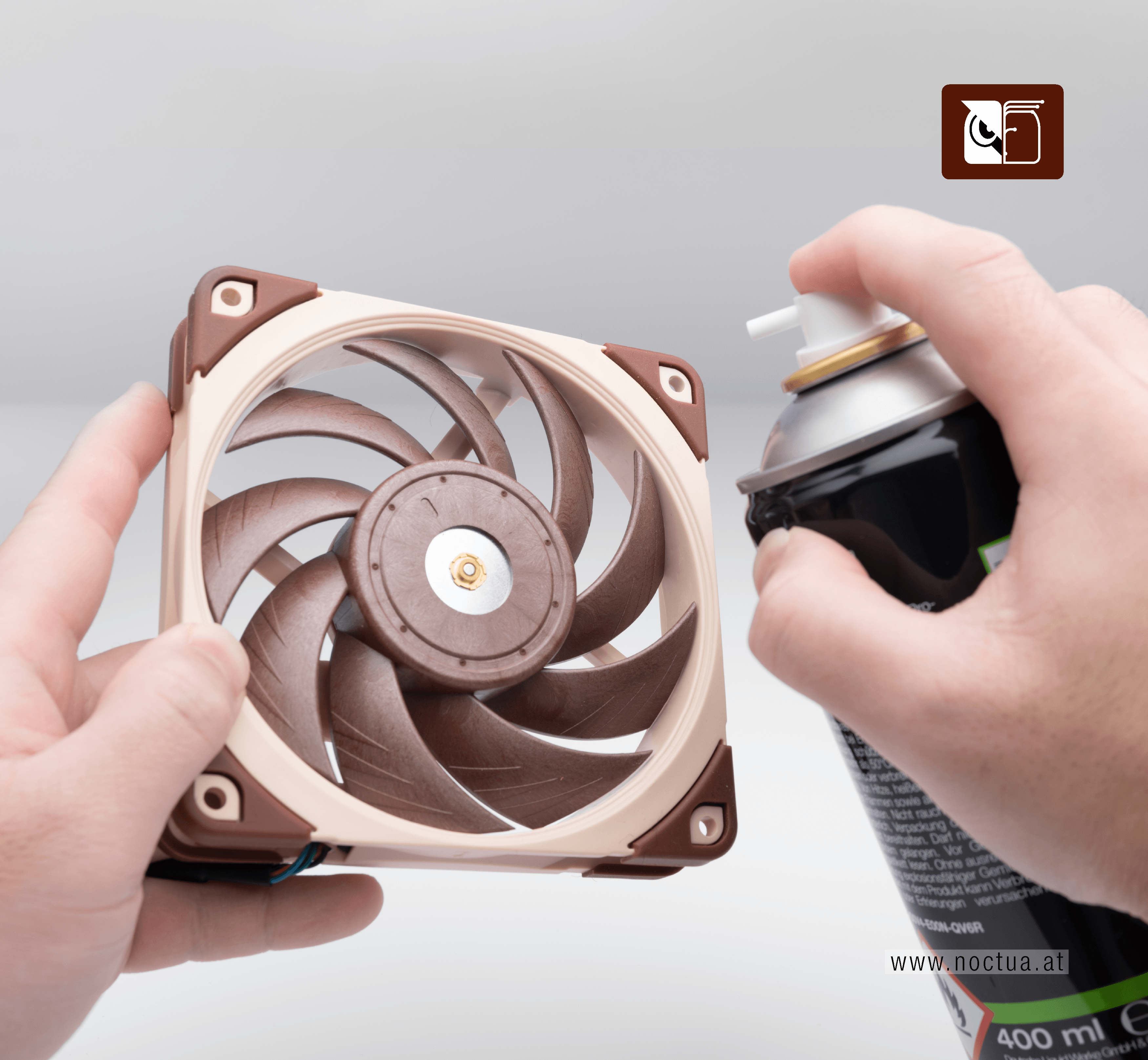 Canned air is pointed towards a fan