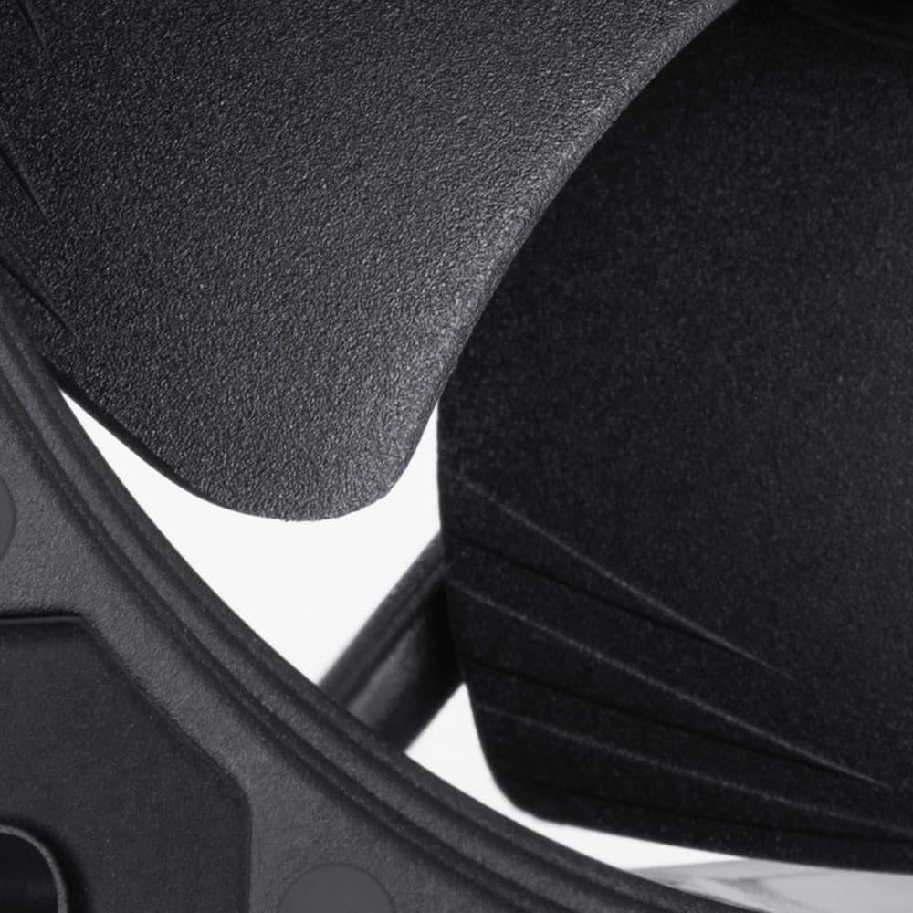 A close-up of a matte black Noctua NF-A9 fan blade, highlighting the textured surface and Flow Acceleration Channels.