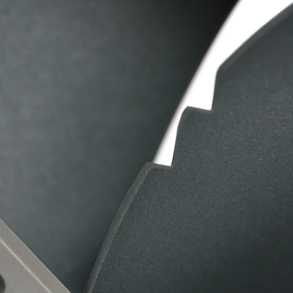 A close-up of the Vortex-Control Notches on the inner frame of a gray Noctua NF-P14 redux fan.