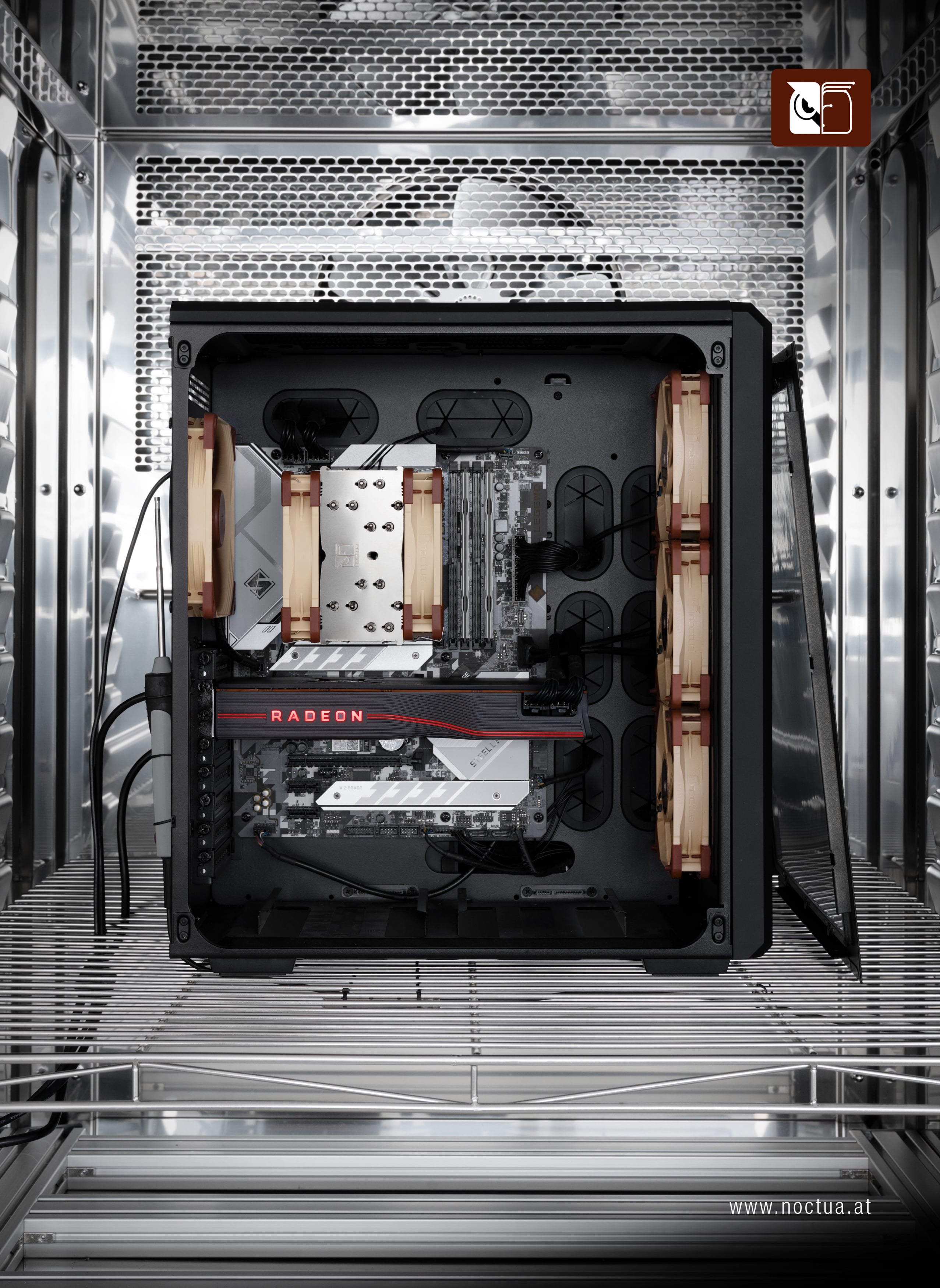 Full view of a PC test setup inside a climate chamber, showcasing Noctua coolers and fans installed for performance testing.